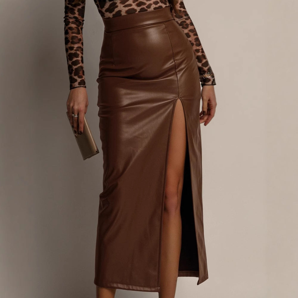 Person wearing a brown leather skirt with a slit, paired with a leopard print top, on a neutral background.