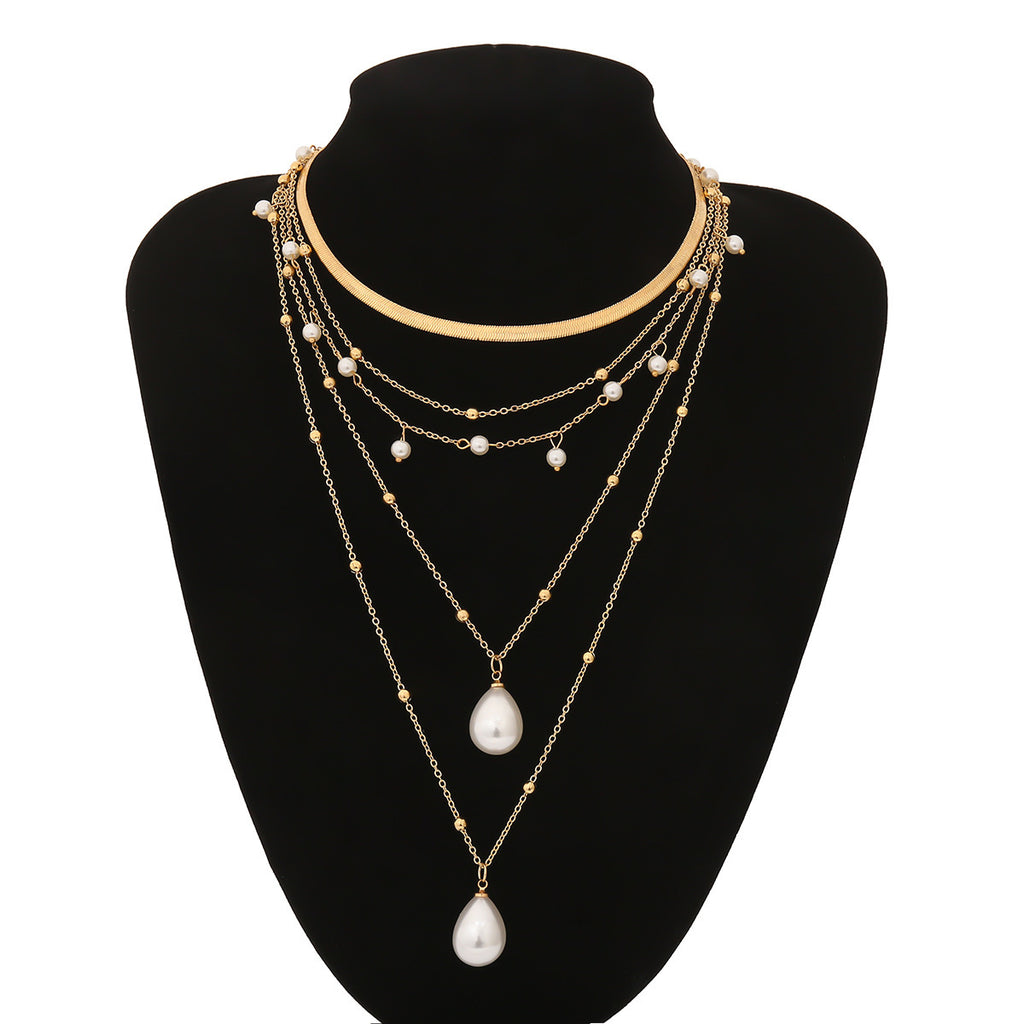 Multi-layered pearl necklace on a black mannequin bust with a white background