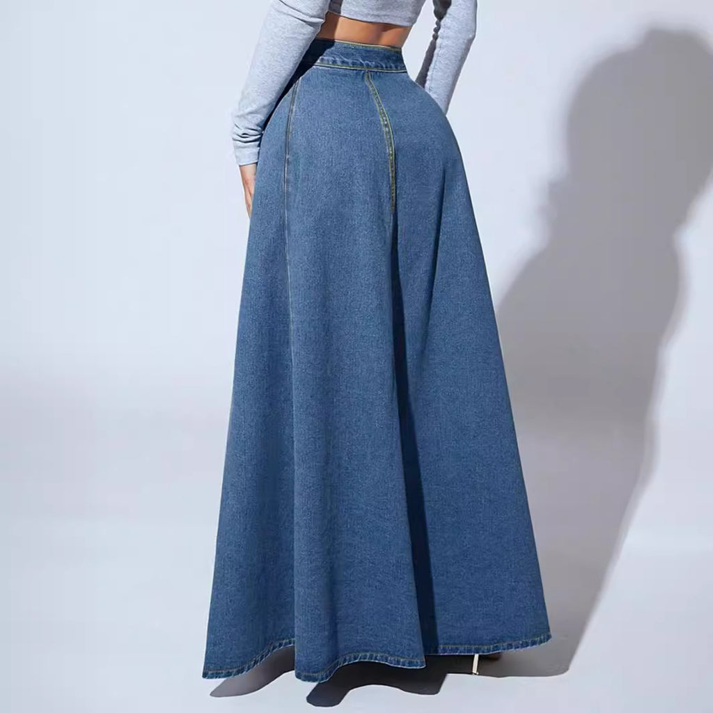 Long denim skirt worn by a person on a plain background