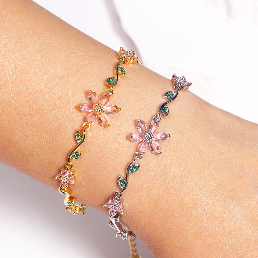 Bracelet with floral designs on a wrist against a white background